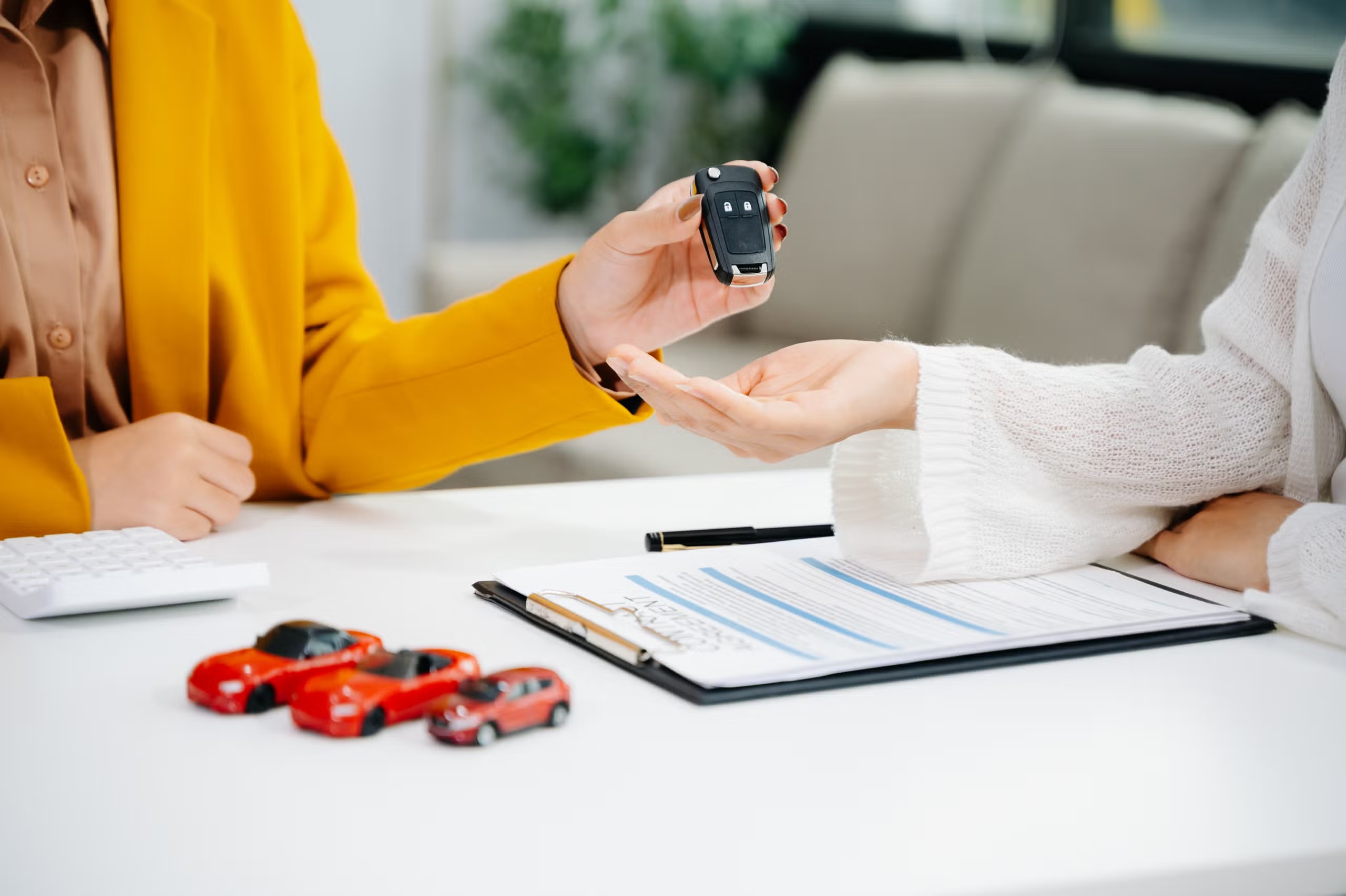 imgi_47_asian-people-car-salesman-or-sales-manager-offers-to-sell-a-car-and-explains-of-signing-a-car-cont
